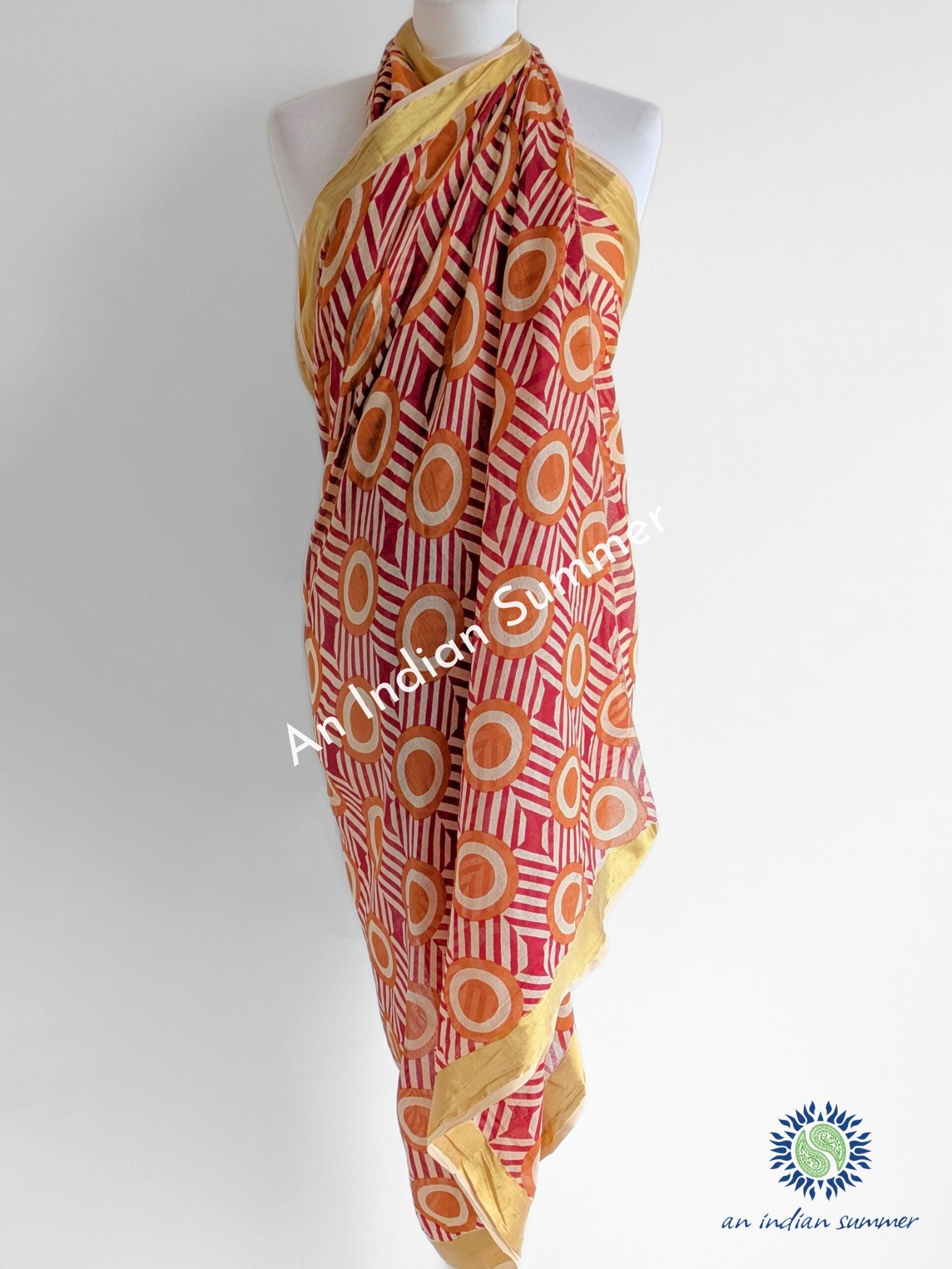 Simba Gold Woven Border Sarong Pareo | Red & Orange Geometric Print | Hand Block Printed | Soft Cotton Voile | An Indian Summer | Luxury Resortwear Swimwear Beachwear | Seasonless Timeless Sustainable Ethical Authentic Artisan Conscious Clothing Lifestyle Brand