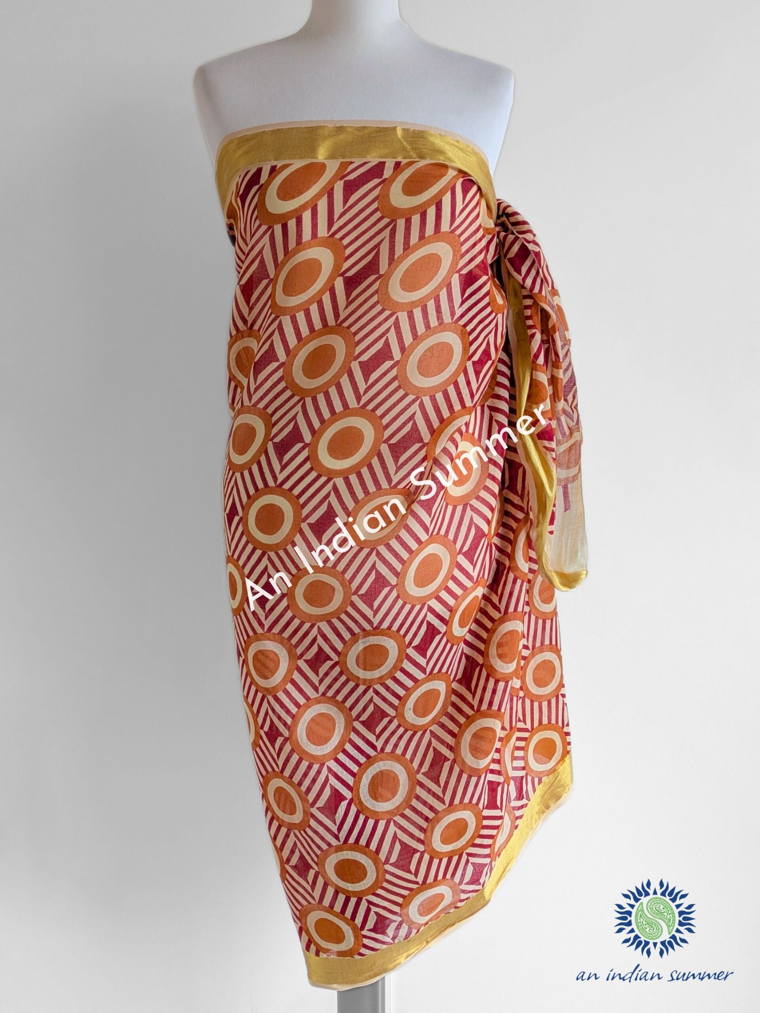 Simba Gold Woven Border Sarong Pareo | Red & Orange Geometric Print | Hand Block Printed | Soft Cotton Voile | An Indian Summer | Luxury Resortwear Swimwear Beachwear | Seasonless Timeless Sustainable Ethical Authentic Artisan Conscious Clothing Lifestyle Brand